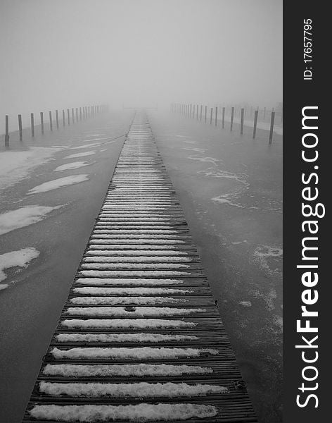 Gangway on a frozen lake in the fog. Gangway on a frozen lake in the fog.