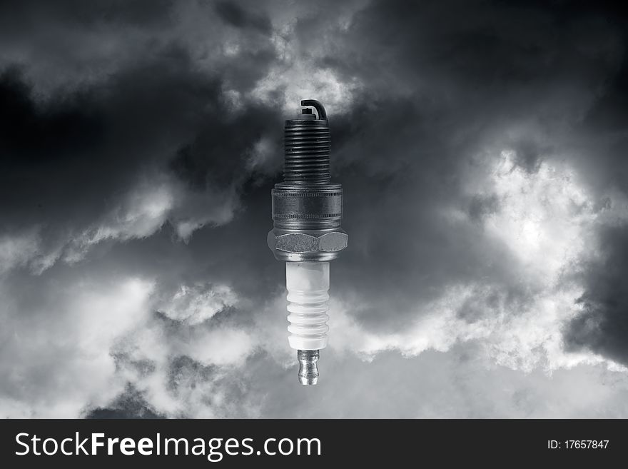 Sparkplug against dark stormy sky and clouds, conceptual with power, electricity. Sparkplug against dark stormy sky and clouds, conceptual with power, electricity