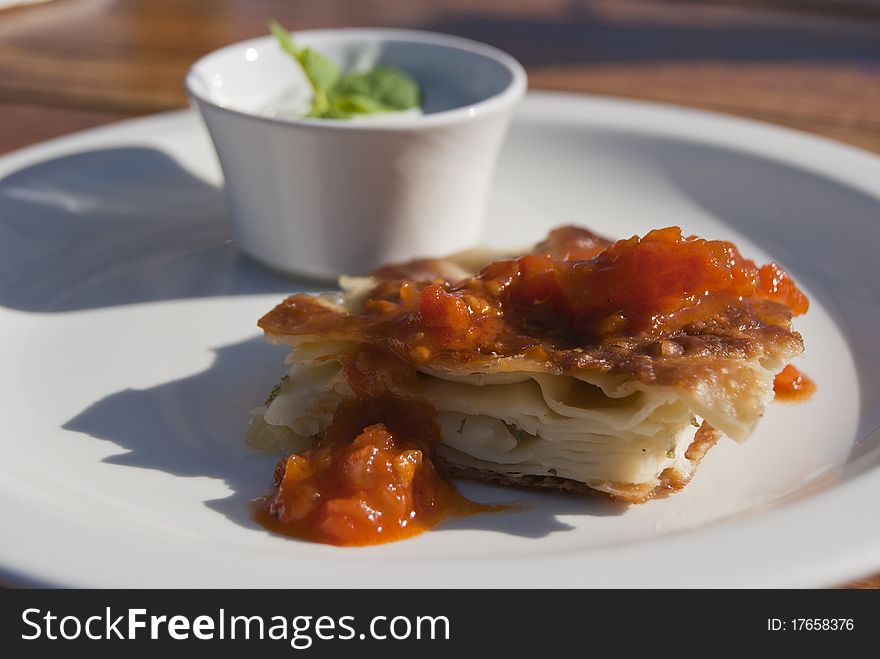 Puff pastry with sauce on the plate. Light snack.