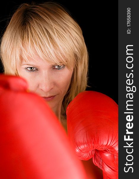 Woman boxing on black background