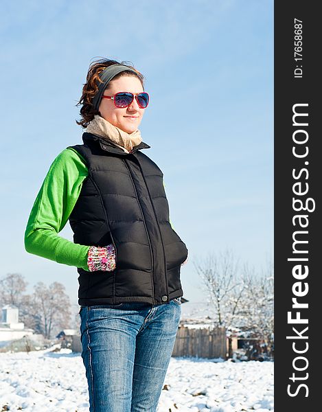 Young woman with red sunglasse in an outdoor winter setting. Young woman with red sunglasse in an outdoor winter setting