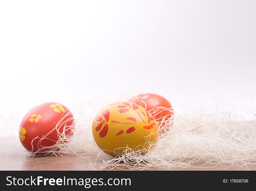 Hand painted colored Easter eggs in hay. Hand painted colored Easter eggs in hay.