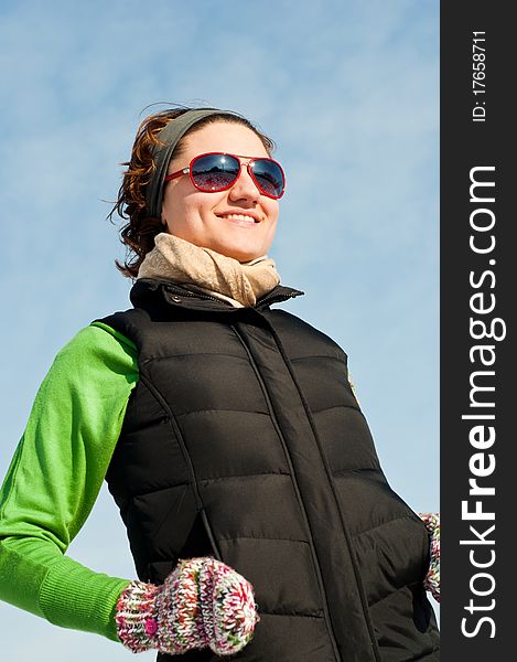 Young woman with red sunglasse in an outdoor winter setting. Young woman with red sunglasse in an outdoor winter setting