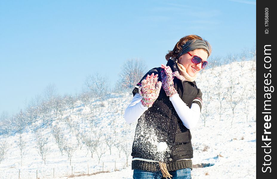 Young woman with red sunglasses in a snow fight. Young woman with red sunglasses in a snow fight