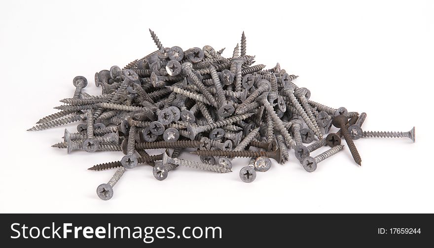 Pile of old screws closeup on white background