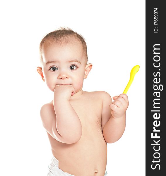 Small beautiful baby girl with yellow spoon on a white background