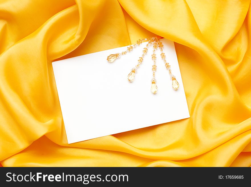 Empty greeting card on yellow satin background. Empty greeting card on yellow satin background