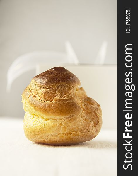 Close up of fresh puff pastry on a white table cloth. Close up of fresh puff pastry on a white table cloth