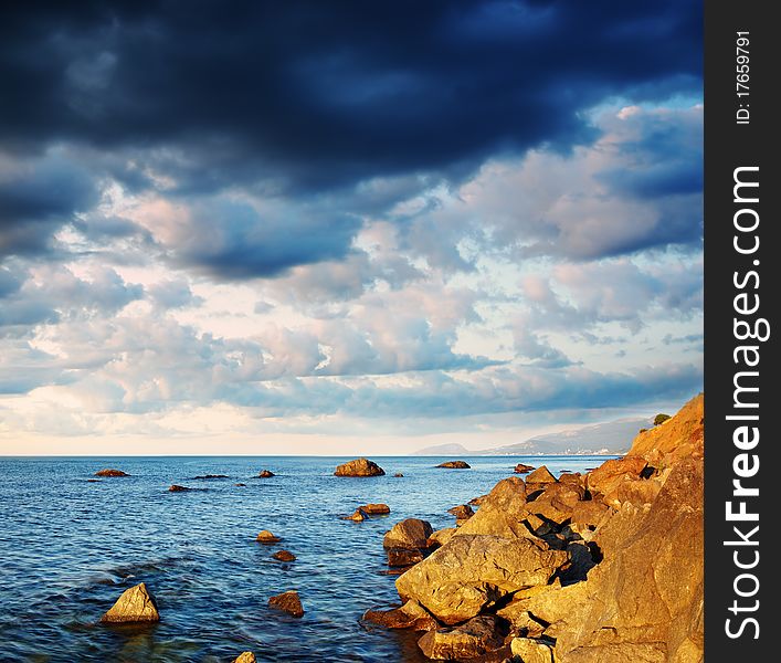 Summer landscape with the sea, stones and the cloudy sky. Crimea, Ukraine. Summer landscape with the sea, stones and the cloudy sky. Crimea, Ukraine.