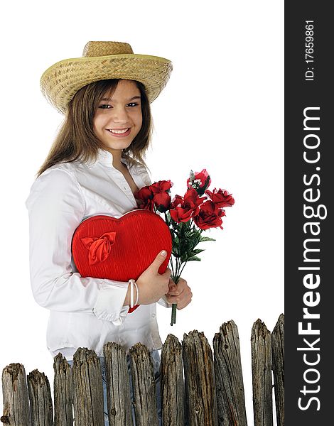 A beautiful young teen delighted with a heart-shaped box of chocolates and red roses. Isolated on white. A beautiful young teen delighted with a heart-shaped box of chocolates and red roses. Isolated on white.