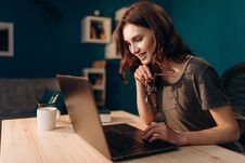 Cheerful Woman Working On Laptop At Evening Time Royalty Free Stock Images