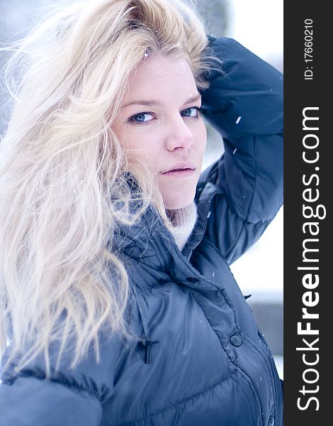 Portrait of an attractive young blonde photographed outdoor in the snow. Portrait of an attractive young blonde photographed outdoor in the snow