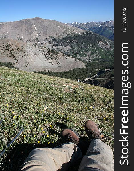 A hiker rests while hiking up Mt. Antero in Colorado. A hiker rests while hiking up Mt. Antero in Colorado