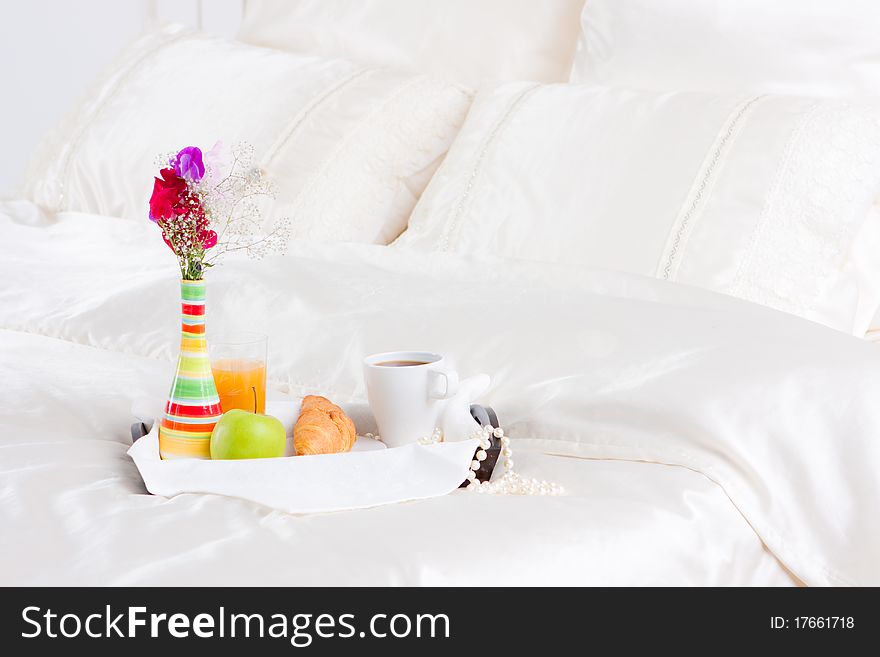 Cup of coffe and flower in vase on tray. Cup of coffe and flower in vase on tray