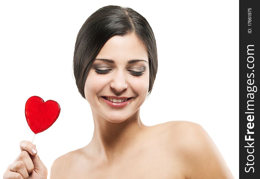 Closeup shot of girl with red heart lolipop isolated on white