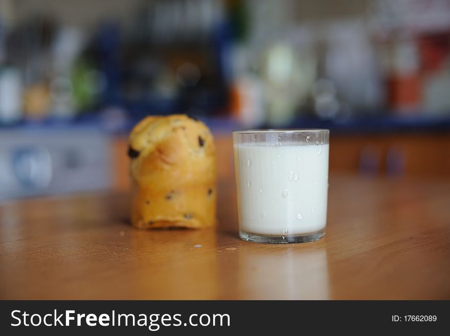 An image of a cake and a glass of milk on a table. An image of a cake and a glass of milk on a table