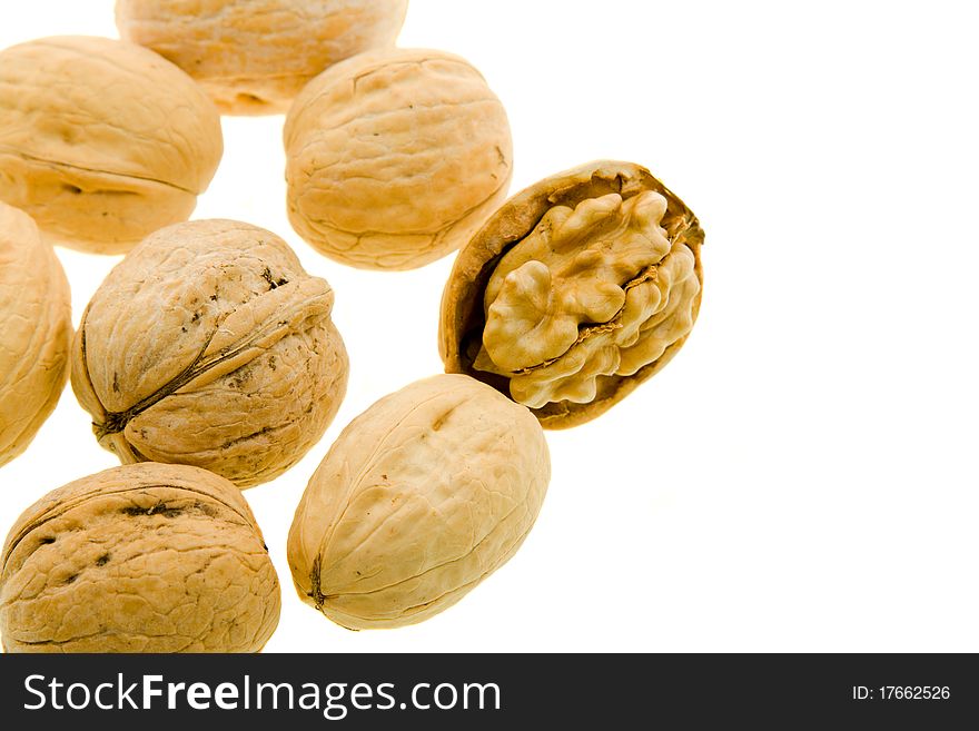 Some walnuts, one of which are split (On a white background)