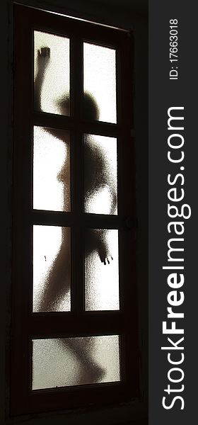 Silhouette Of The Girl Behind A Door