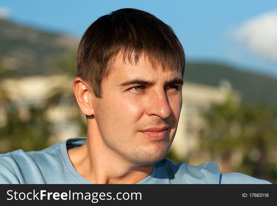 Portrait of a man against the backdrop of greenery