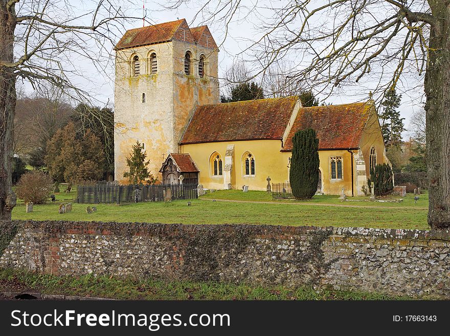 Medieval English Village Church and Tower viewed from the graveyard. Medieval English Village Church and Tower viewed from the graveyard