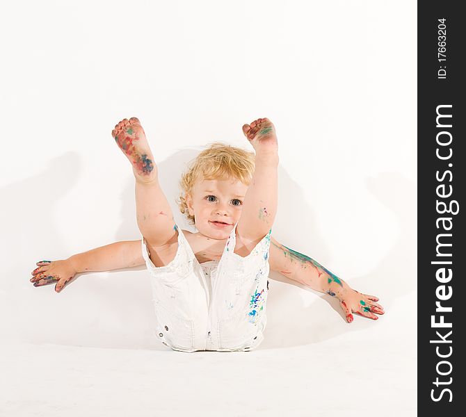 Beautiful playful little child playing with colors isolated on white background. Beautiful playful little child playing with colors isolated on white background