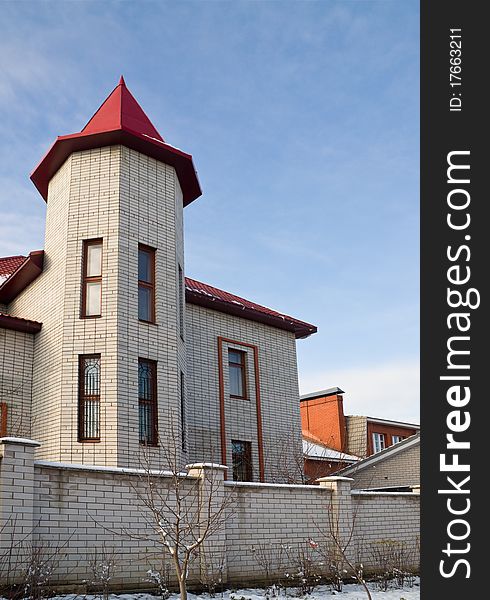 Urban house with red roof in the form of turrets. Urban house with red roof in the form of turrets