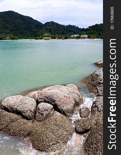 Tropical rocky beach with rain forest in Malaysia