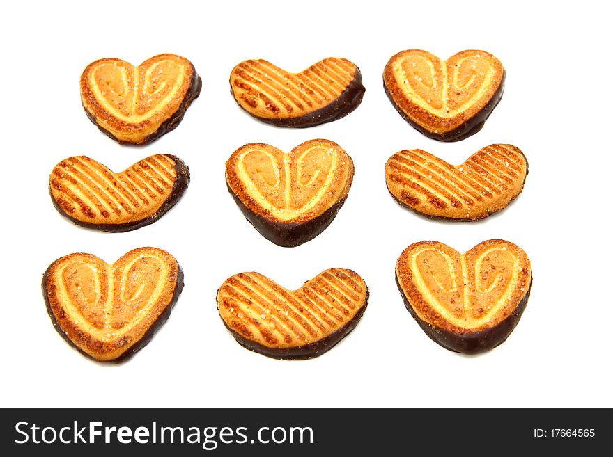 Cookies in the form of heart with chocolate on a white background