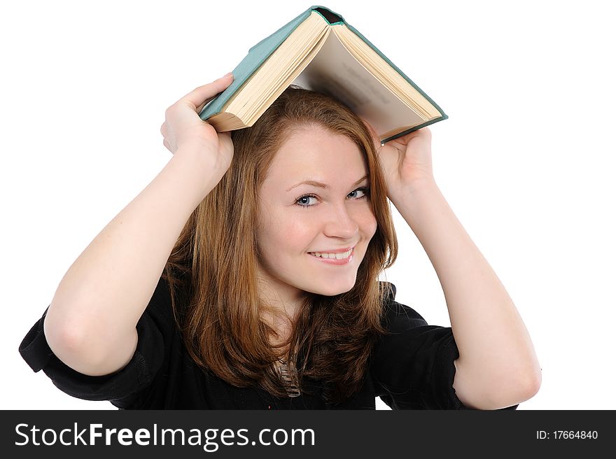 Girl with thick and heavy textbook over her head. Girl with thick and heavy textbook over her head