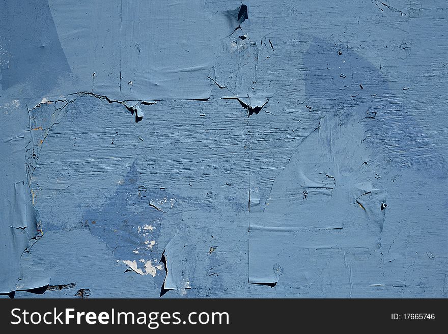 Blue wooden wall with pieces of paper. Blue wooden wall with pieces of paper