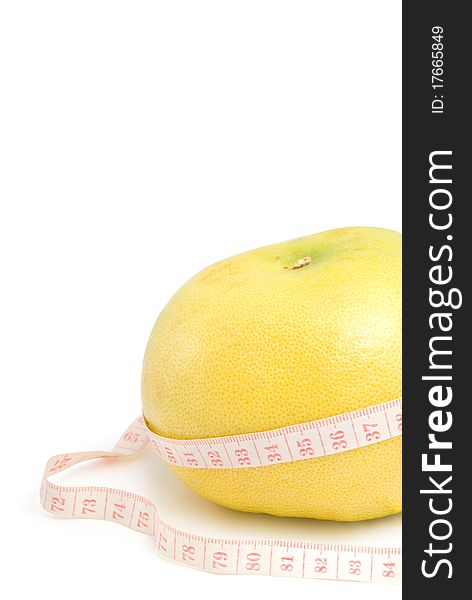 Grapefruit in the measuring tape, is isolated on a white background. Grapefruit in the measuring tape, is isolated on a white background