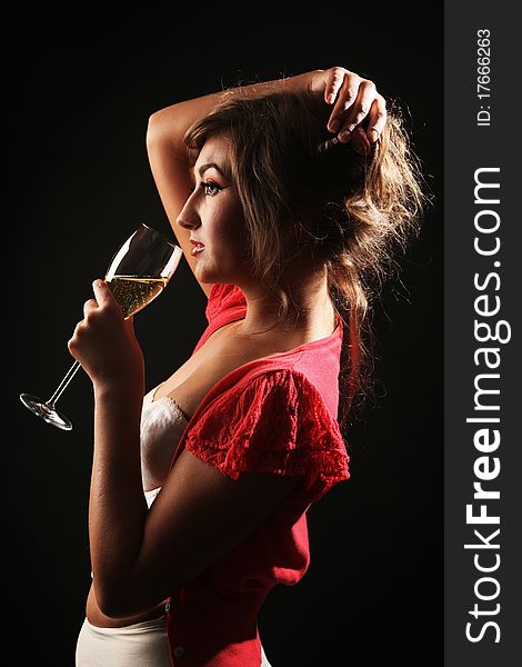 Beautiful woman with glass of champagne in studio