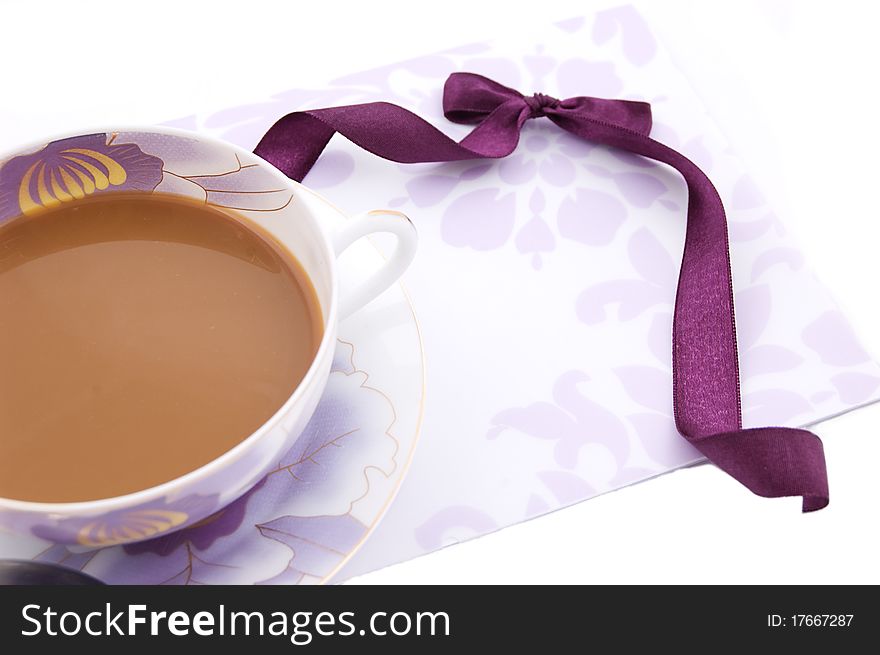 Cup of cappuccino, blank note and violet ribbon. Cup of cappuccino, blank note and violet ribbon