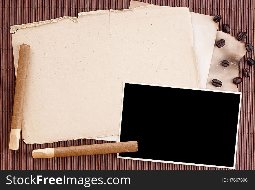 Old tattered sheets of paper on brown wood background for design creativity.