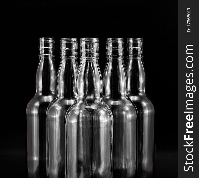 Empty bottles collection, colorless, isolated on black backgrounde