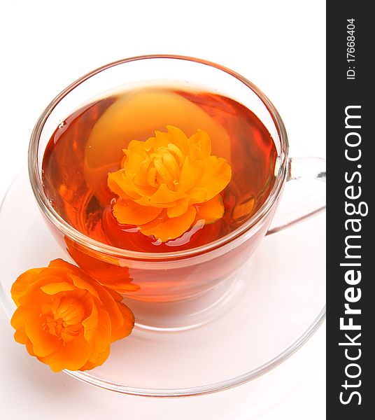 Cup with tea and a flower on a white background