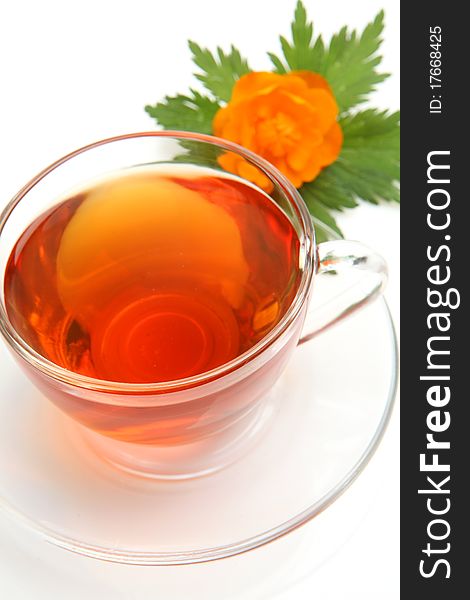 Cup with tea and a flower on a white background