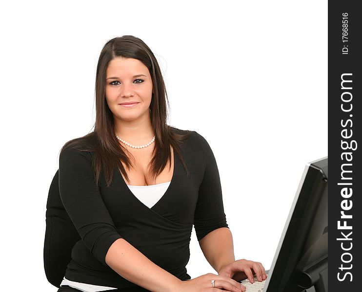 A cheerful young woman working on her computer. A cheerful young woman working on her computer.