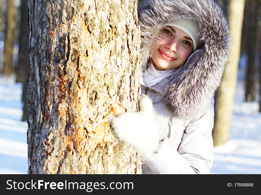 Girl winter portrait on background of trees