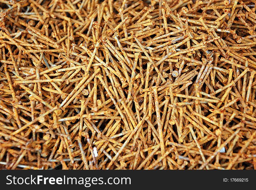 Background of the old rusty nails, close-up. Focus is on the nails in the front and falls off a little in the back