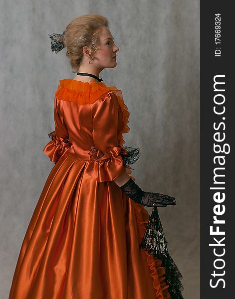 Studio shot of standing girl with baroque dress and hairstyle. Studio shot of standing girl with baroque dress and hairstyle