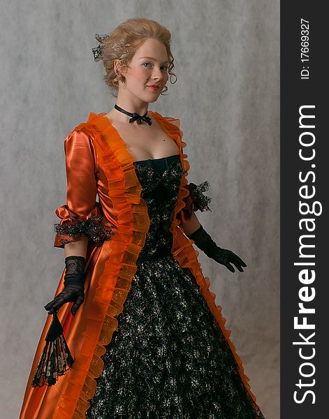 Studio shot of standing girl with baroque dress and hairstyle. Studio shot of standing girl with baroque dress and hairstyle