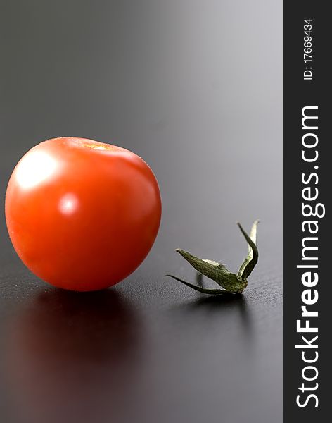 Small cherry tomato with a branch