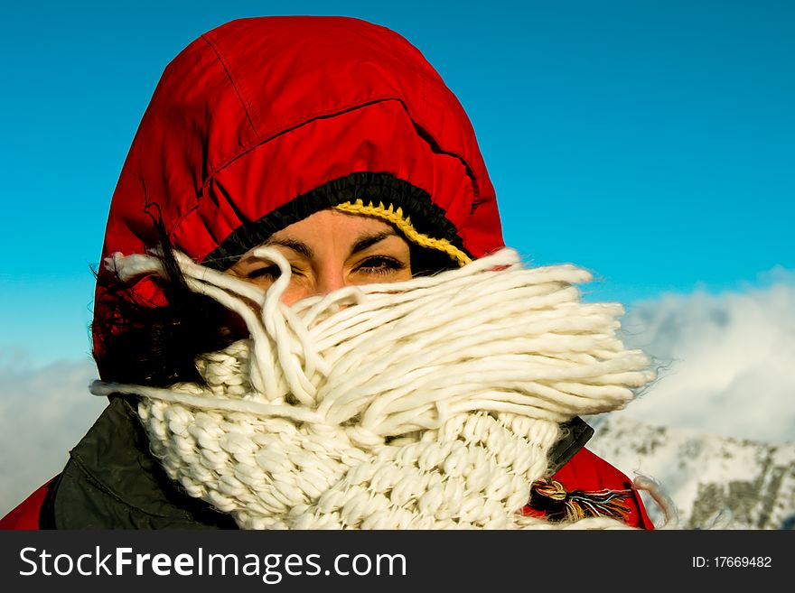 Girl's face is resisting a wind on top of mountain. Girl's face is resisting a wind on top of mountain