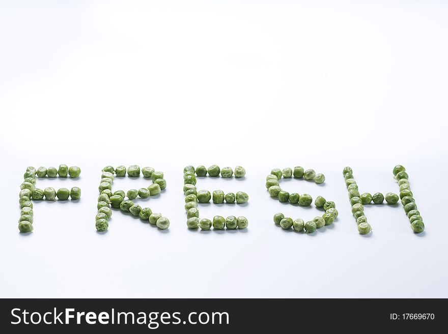 Word fresh created from peas on a white background