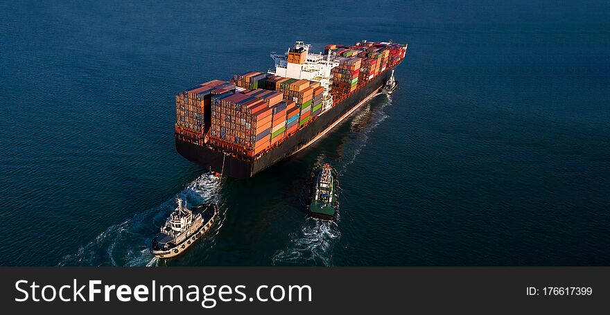 Container cargo ship business commercial trade import export logistic transportation container box oversea worldwide by container vessel boat freight shipping maritime with tugboat.