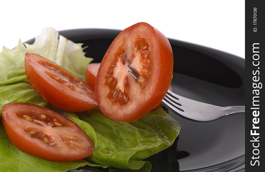Tomato on fork with white background