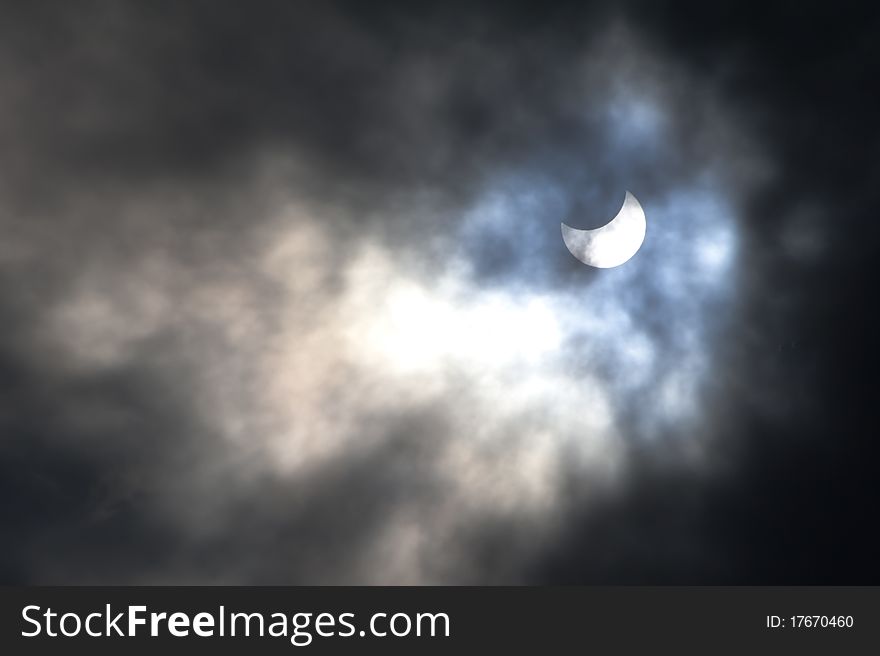 The sun is partially hidden by an eclipse on a cloudy day over Jerusalem. The sun is partially hidden by an eclipse on a cloudy day over Jerusalem.