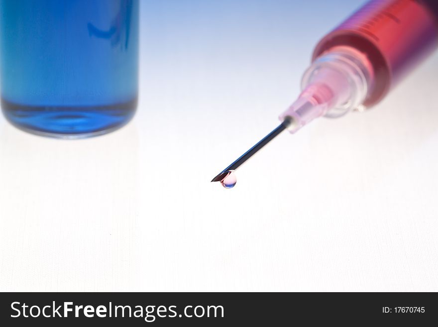 Red medication with colorful background. Lit from below, blended blue-colored background.
