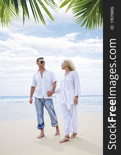 Portrait of young nice couple having good time on the beach